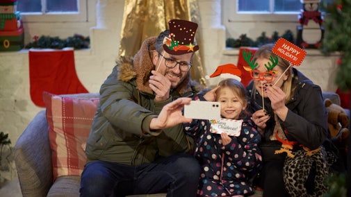 A family using props to take festive selfies
